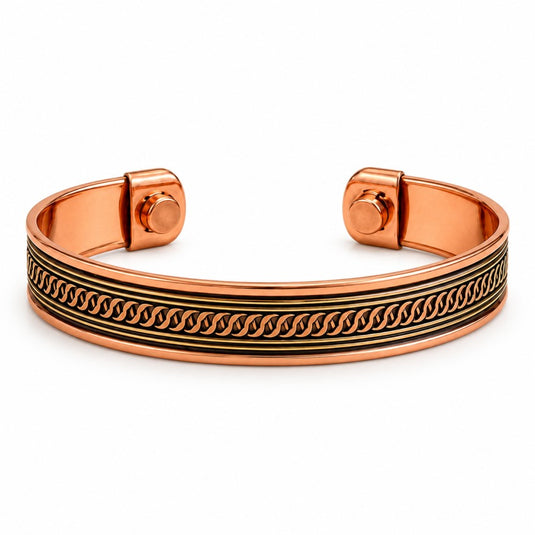 A polished copper-colored cuff bracelet with a black engraved wave pattern, displayed on a clean white background.
